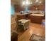 Well-lit kitchen with an island, dining area, and wood cabinetry at 14751 E 24Th Ave, Aurora, CO 80011