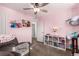 This bedroom features a ceiling fan, plush carpet, and plenty of natural light at 17470 E 95Th Pl, Commerce City, CO 80022