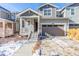 Charming two-story home with a covered front porch, two-car garage, and well-maintained yard at 17470 E 95Th Pl, Commerce City, CO 80022