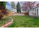 Backyard with green grass and white picket fence at 5292 Lichen Pl, Boulder, CO 80301