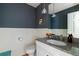 This half bathroom features wainscotting, modern fixtures, and a granite countertop at 5292 Lichen Pl, Boulder, CO 80301