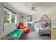 Playful bedroom with a canopy bed, an orange arm chair, and plenty of light at 5292 Lichen Pl, Boulder, CO 80301