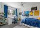 Large bedroom with a bed, a desk, lots of posters, and natural light at 5292 Lichen Pl, Boulder, CO 80301