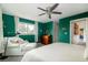 Bright bedroom features a ceiling fan, a large window, and a comfortable lounge area at 5292 Lichen Pl, Boulder, CO 80301