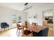 Dining room featuring a wood table, stylish light fixture, and a doorway into a modern kitchen at 5292 Lichen Pl, Boulder, CO 80301