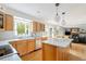 Open-concept kitchen with an island and views into a cozy living room with fireplace at 5292 Lichen Pl, Boulder, CO 80301