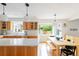 Bright kitchen featuring quartz countertops, pendant lighting, and an adjacent dining area at 5292 Lichen Pl, Boulder, CO 80301