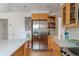 Spacious kitchen with an island, stainless refrigerator, and wood cabinetry at 5292 Lichen Pl, Boulder, CO 80301