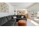 Cozy living room featuring a large sectional sofa, leather ottoman, and an open view into a modern kitchen at 5292 Lichen Pl, Boulder, CO 80301