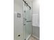 Walk-in shower featuring a frameless glass door, white subway tile, and modern fixtures at 5292 Lichen Pl, Boulder, CO 80301