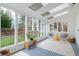 Sunroom with floor-to-ceiling windows and skylights offers views of the spacious, fenced backyard at 5292 Lichen Pl, Boulder, CO 80301