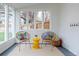 Inviting sunroom features white shiplap walls, neutral rug, and comfortable seating, all overlooking backyard at 5292 Lichen Pl, Boulder, CO 80301