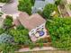 Aerial view of a backyard patio area with outdoor seating, surrounded by mature trees and landscaping at 6105 W Long Dr, Littleton, CO 80123