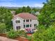 Aerial view of a home with outdoor seating surrounded by greenery at 6105 W Long Dr, Littleton, CO 80123