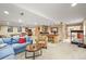 Open basement with a bar, treadmill, and comfortable furnishings perfect for entertaining at 6105 W Long Dr, Littleton, CO 80123
