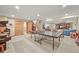 Spacious basement with open floor plan, ping pong table, arcade game and living space at 6105 W Long Dr, Littleton, CO 80123