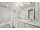 Bathroom featuring double sinks, tile floors, a shower and great lighting at 6105 W Long Dr, Littleton, CO 80123