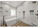 Sleek bathroom featuring a soaking tub, a walk-in shower with patterned tile, and modern fixtures at 6105 W Long Dr, Littleton, CO 80123