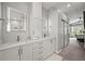 Bright bathroom with double vanity, modern lighting, and white cabinets in a contemporary style home at 6105 W Long Dr, Littleton, CO 80123