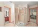 Bathroom featuring a glass shower with tile and doors leading to other rooms in the home at 6105 W Long Dr, Littleton, CO 80123
