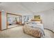Bedroom with a large mirror and a large window giving plenty of natural light at 6105 W Long Dr, Littleton, CO 80123