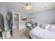 Cozy bedroom with a ceiling fan, desk area with television and comfortable furniture at 6105 W Long Dr, Littleton, CO 80123