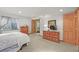Bedroom featuring wood dressers, carpet, and a cozy sleeping space with a window at 6105 W Long Dr, Littleton, CO 80123