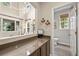 Butler's pantry connecting to a living space and bathroom; features stone counters and cabinetry at 6105 W Long Dr, Littleton, CO 80123