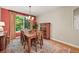 Dining room with wood table and chairs, rug, and window with natural light at 6105 W Long Dr, Littleton, CO 80123