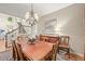 Dining room with wood table, chandelier, and view of staircase at 6105 W Long Dr, Littleton, CO 80123