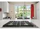 Close-up of a gas cooktop on an island with stainless appliances and white cabinets at 6105 W Long Dr, Littleton, CO 80123