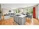 Open floor plan features kitchen with stainless appliances, center island and eat-in dining area and access to the living room at 6105 W Long Dr, Littleton, CO 80123