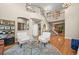 Elegant living room features a staircase, hardwood floors, stylish furniture, and an open layout at 6105 W Long Dr, Littleton, CO 80123
