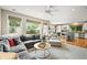 Open living room with views into the kitchen and a backyard; well lit with plentiful windows at 6105 W Long Dr, Littleton, CO 80123