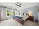 Spacious main bedroom with vaulted ceilings, a ceiling fan, large windows, and plush carpeting for a restful retreat at 6105 W Long Dr, Littleton, CO 80123