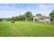 Large grassy yard with a charming wooden fence and views of the home at 6105 W Long Dr, Littleton, CO 80123