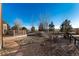 A spacious backyard featuring a wooden deck, gravel groundcover, and a wooden fence with views of the Colorado plains at 1120 Antelope W Dr, Bennett, CO 80102