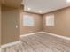 This basement space offers two windows and vinyl flooring at 1120 Antelope W Dr, Bennett, CO 80102