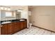 Bathroom with double vanity, black countertop, and a toilet at 1120 Antelope W Dr, Bennett, CO 80102