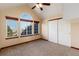 This bedroom offers a vaulted ceiling, a large window and carpet at 1120 Antelope W Dr, Bennett, CO 80102