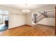 Open dining area with hardwood floors, a chandelier, and staircase access, creating an inviting space at 1120 Antelope W Dr, Bennett, CO 80102