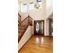 Elegant foyer with hardwood floors, a grand staircase, a decorative chandelier and a striking front door at 1120 Antelope W Dr, Bennett, CO 80102