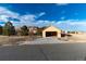 Detached garage with a concrete driveway and partially open doors at 1120 Antelope W Dr, Bennett, CO 80102