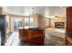 Open-concept kitchen flows into the living area, complete with an island, fireplace, and lots of natural light at 1120 Antelope W Dr, Bennett, CO 80102
