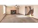 Inviting living room features a fireplace and staircase, perfect for cozy evenings and easy access to upper floors at 1120 Antelope W Dr, Bennett, CO 80102