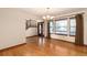 Bright living room showcasing hardwood floors, large windows, and stairs to the second floor at 1120 Antelope W Dr, Bennett, CO 80102