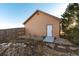 Exterior view of a small outbuilding with brown siding and a white door at 1120 Antelope W Dr, Bennett, CO 80102