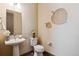 Bright bathroom with pedestal sink and decorative wall art at 24322 E Mineral Dr, Aurora, CO 80016