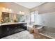 Modern bathroom with dual vanity, soaking tub, and glass-enclosed shower at 24322 E Mineral Dr, Aurora, CO 80016