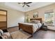 Bedroom with tray ceilings, a ceiling fan, and large windows for natural light at 24322 E Mineral Dr, Aurora, CO 80016